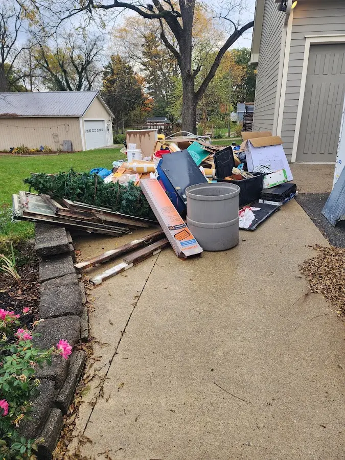 Dumpster being loaded with debris for Roofing Dumpster Rental in Fairway